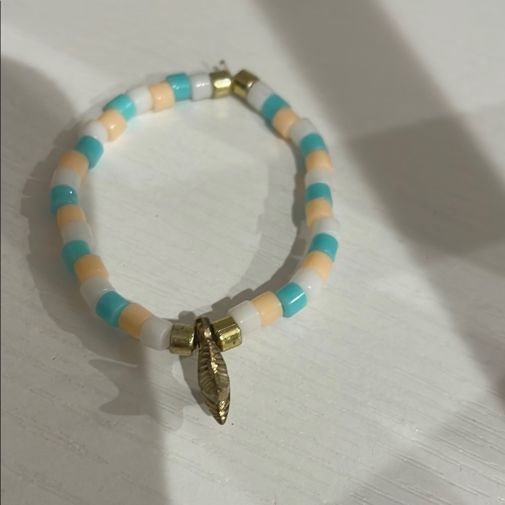 Gold and White Beaded Bracelet with Charm